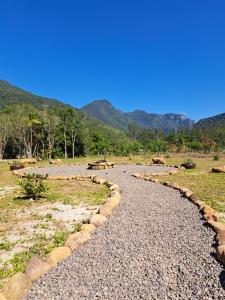 a gravel road with mountains in the background at Sombra do baú - Aurora in Timbe do Sul