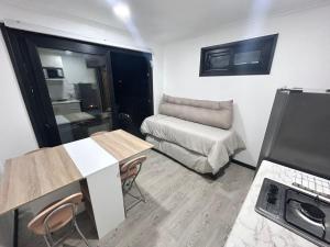 a small room with a bed and a table and chairs at Cabañas Vista Mar in Los Vilos +8 photos