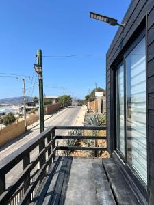 a building with a fence next to a street at Cabañas Vista Mar in Los Vilos