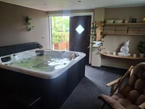 a large bath tub in a room with at De Fugelsang in Jonkersland