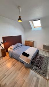 a bedroom with a large bed and a window at Montoir-de-Bretagne in Montoir-de-Bretagne