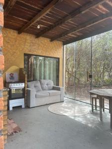 a living room with a couch and a table at Golden refuge in Vale do Capão in Passagem