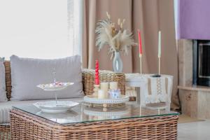 a living room with a glass coffee table with candles at Christina's Home in Skiathos