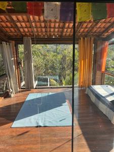 a room with a yoga mat on the floor at Golden refuge in Vale do Capão in Passagem +20 photos