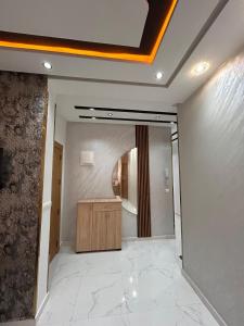 a bathroom with a sink and a mirror in a room at Jaouhar immo in Martil