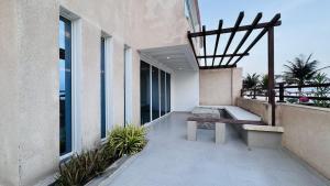 a bench on the balcony of a building at Family Beach Villas in Salalah