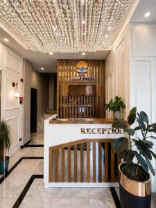 a reception desk in a lobby with a coffered ceiling at Ber Mai İnci Hotel Antalya in Antalya