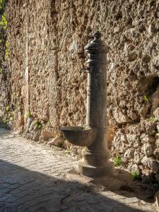 a fire hydrant sitting next to a stone wall at Da Nonna Pasqualina in Ciorlano