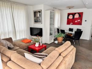 a living room with a couch and a table at 5 - Persons Lakeside 41 Bungalow in Ewijk