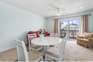 a dining room with a white table and chairs at MarzyMagic Oceanview's in Myrtle Beach