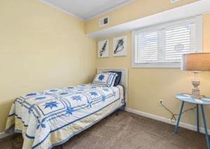 a small bedroom with a bed and a table at MarzyMagic Oceanview's in Myrtle Beach