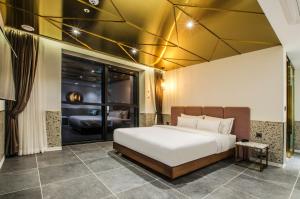 a bedroom with a white bed and a large window at Hotel the Castle Jamsil#1 in Seoul