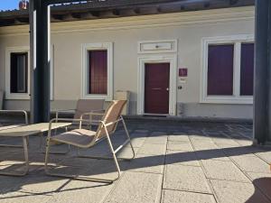 a pair of chairs and a table on a patio at Camere AL Borgo in Santa Sofia