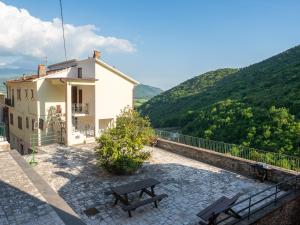 a building with a bench on a patio with mountains at Da Nonna Pasqualina in Ciorlano +185 photos