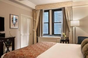 a hotel room with a bed and a window at Warwick New York in New York