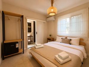 a bedroom with a large bed and a window at The One Alacatı in Çeşme