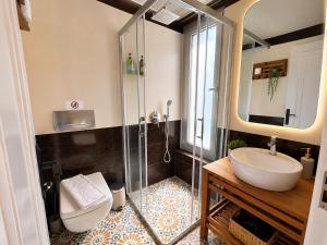 a bathroom with a sink and a glass shower at The One Alacatı in Çeşme