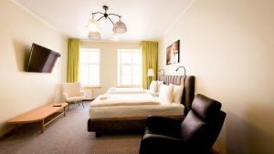a hotel room with a bed and a couch at White Palace in Riga