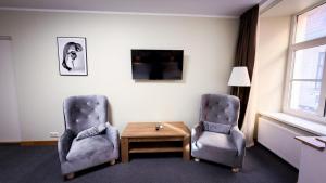 two chairs and a coffee table in a room at White Palace in Riga