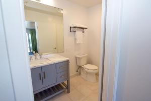 a bathroom with a sink and a toilet and a mirror at Carousel Beach Inn in Santa Cruz +22 photos