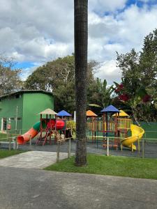 a park with a playground with slides and a play structure at Pousada do Rei in Sarzedo