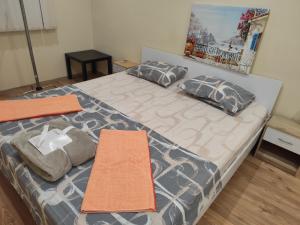a bedroom with a bed with two pillows on it at Grand and Prime Central Apartments Varna in Varna City +40 photos
