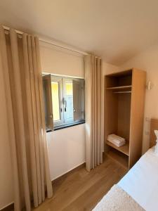 a bedroom with a bed and a window in it at B&B Berlenga 4 in Nazaré +5 photos