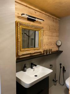 a bathroom with a white sink and a mirror at Alp n' rose in Hasliberg +41 photos