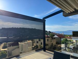 a view from the balcony of a house with large windows at Golden Sunset Sutivan - Exclusive 4-Star Apartment in Sutivan +29 photos