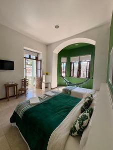 a large bedroom with two beds and a mirror at Pousada Casa Imperatriz - Rua Teresa in Petrópolis