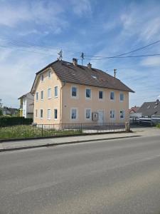 a large house on the side of a street at My Pension City Großaitingen - Augsburg in Großaitingen