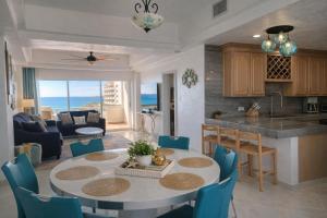 a kitchen and living room with a table and chairs at Updated Beachfront Condo on Sandy Beach, Las Palmas Resort, 24hrs Security, Free Parking, Free Wi-Fi in Puerto Peñasco