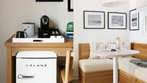 a kitchen with a table and a chair next to a table at The Penny Lane in Hampton Bays