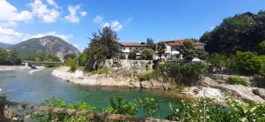 a house on a hill next to a river at Dimora Da Castello Lago Maggiore in Gravellona Toce