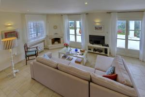 a living room with a couch and a fireplace at Andromeda Villa in Tranakatika