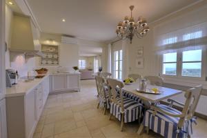 a kitchen with a table and chairs and a dining room at Andromeda Villa in Tranakatika