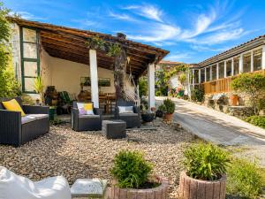 a patio with couches and plants in front of a building at Casa dos Invernos in Paçô