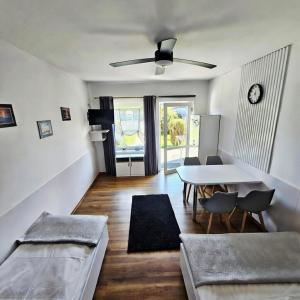 a living room with a table and a dining room at Fox pokoje-apartament-domki in Władysławowo +13 photos