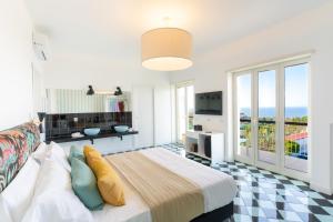 a bedroom with a bed and a view of the ocean at Vanity Suite in Sorrento