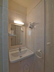 a bathroom with a sink and a mirror at Hotel Les Oliviers in Fayence +31 photos