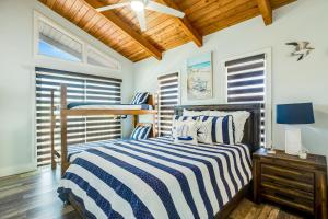 a bedroom with a bed and a bunk bed at BP05FLR Tradewinds Treat in Big Pine Key