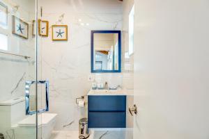 a bathroom with a sink and a toilet and a mirror at BP05FLR Tradewinds Treat in Big Pine Key +21 photos