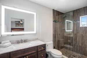a bathroom with a toilet and a sink and a shower at BP04FLR Sunset Villa in Big Pine Key +25 photos