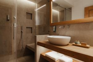 a bathroom with a sink and a shower at Hotel Colbricon in San Martino di Castrozza +41 photos