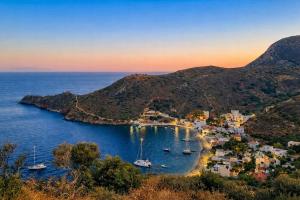 an island with boats in the water at sunset at Castello in Porto Kagio