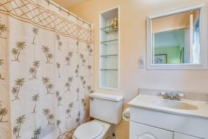a bathroom with a toilet and a sink and a mirror at BC277FLR Sapphire Sabbatical in Key West +21 photos