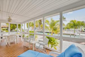 a living room with views of the water and palm trees at BC277FLR Sapphire Sabbatical in Key West