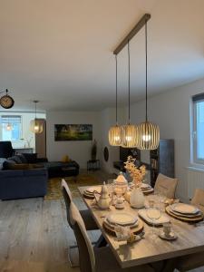 a living room with a wooden table with chairs at Apartment Hornberg-Melisa in Hornberg +38 photos