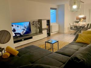 a living room with a couch and a flat screen tv at Apartment Hornberg-Melisa in Hornberg