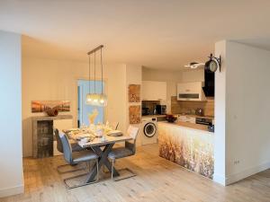 a dining room and kitchen with a table and chairs at Apartment Hornberg-Melisa in Hornberg